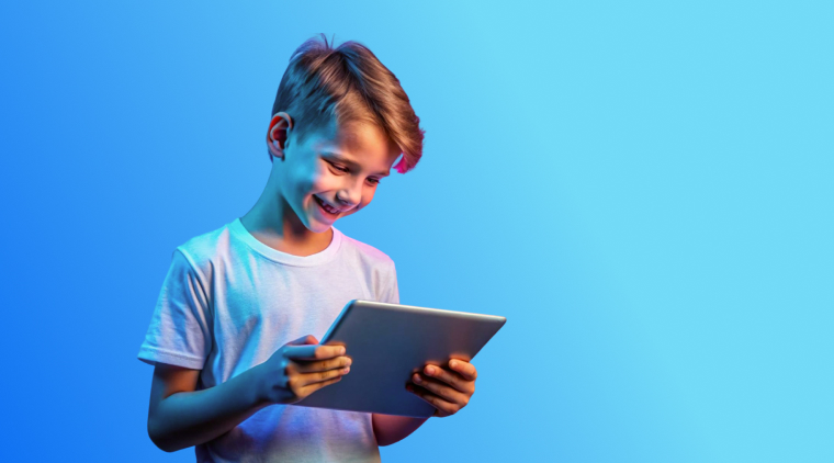 A cheerful young boy, about 9 years old, lounges on a cozy rug while intently using an iPad, representing the concept of "iPad kids"—a generation of children immersed in tablet-based digital play and learning from an early age